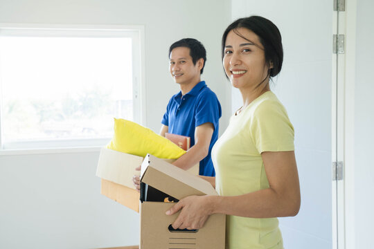 relocation to new house. woman carrying stuff box and moving in new apartment.