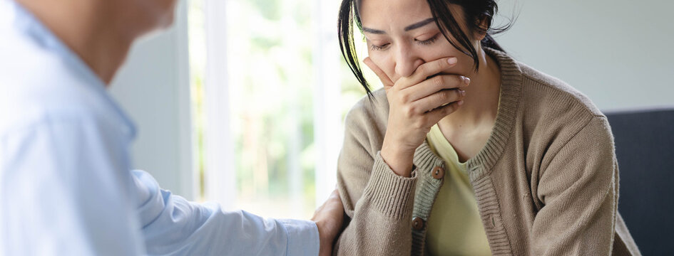 Counselor touching friend shoulder and encouraging to help relieve her sad