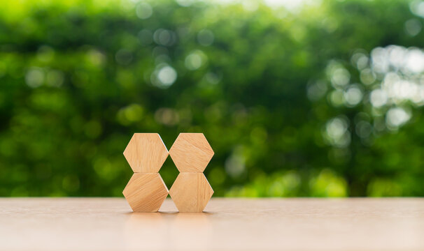 Hexagonal wooden blocks arranged in a connected pattern, representing teamwork, collaboration, connection, and organizational structure.