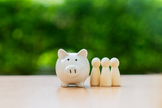 Piggy bank on table with green nature background, Save money for prepare retirement concept.