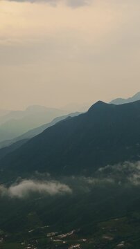 Vertical Aerial View of Layered Mountain Ridges and Misty Clouds in Sa Pa Vietnam landscape