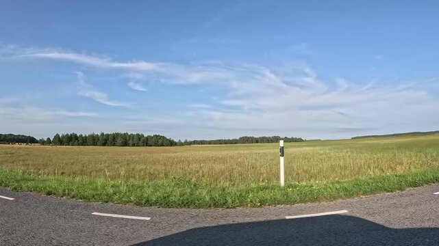 road in the countryside and sky with some clouds