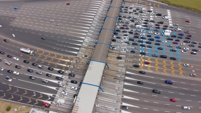 Aerial view of the Milan South toll barrier on the A1 highway, showing transport infrastructure, road lanes and vehicle circulation.
