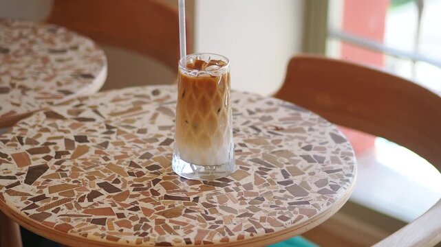 Iced coffee sits on a table in a cafe
