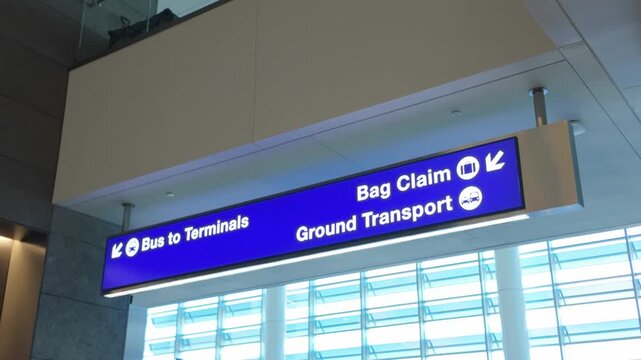 Gimbal close-up panning shot of airport signage in Terminal B at LAX in Los Angeles, California. 4K