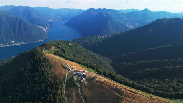 Expansive aerial footage showcasing the breathtaking mountain landscape of monte san primo, revealing the stunning blue waters of lake como below
