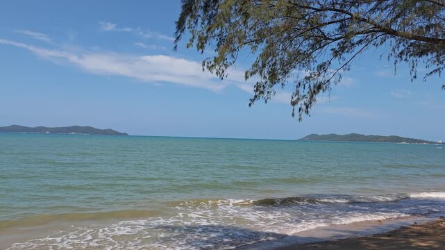 beach with soft  sand, crystal-clear blue sea, and a peaceful atmosphere under natural sunlight. 