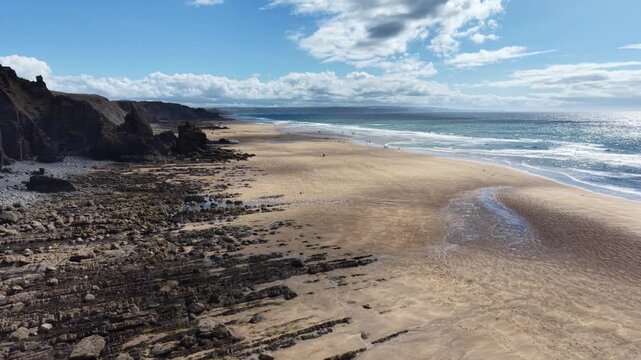 Dappled evening light at Sandymouth Bay beach in Cornwall