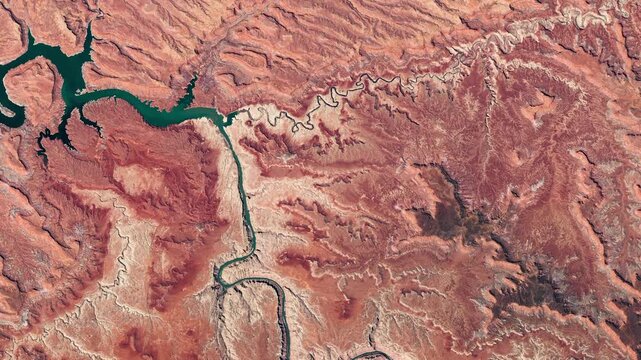 Top view on canyonlands, river among red rocks. Camera is moving backward and right. Animation based on image by NASA