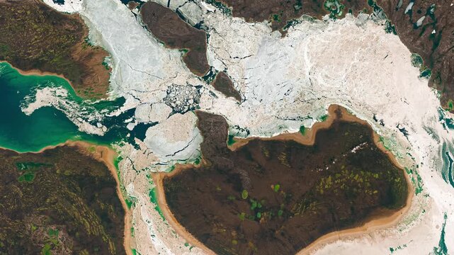 Aerial shot of ice in sea waters near coast. Cold water concept. Camera is moving backward and right. Animation based on image by NASA
