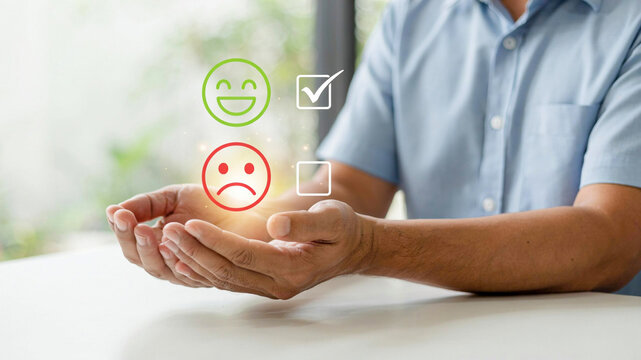 Customer satisfaction concept illustrated with icons of happy and sad faces in a person's hands