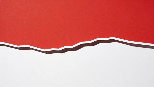 Red paper tears across white surface