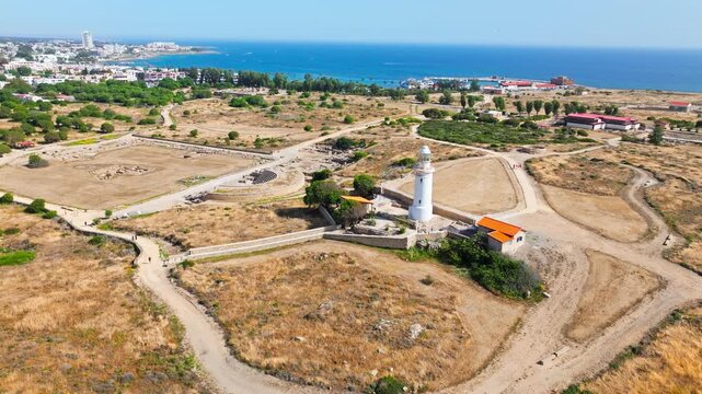 Aerial view over the Archaeological Site of Nea Paphos in Cyprus. Ancient ruins, pathways, lighthouse area and distant sea create a scenic cultural landscape.