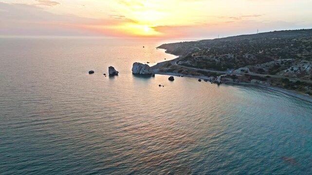 Aerial sunset view of Petra tou Romiou near Paphos, Cyprus. Also known as Aphrodite&rsquo;s Rock, this famous landmark features tranquil sea, coastal cliffs and warm evening light.