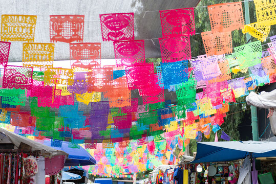 Colorful papel picado banners decorating a traditional Mexican street market