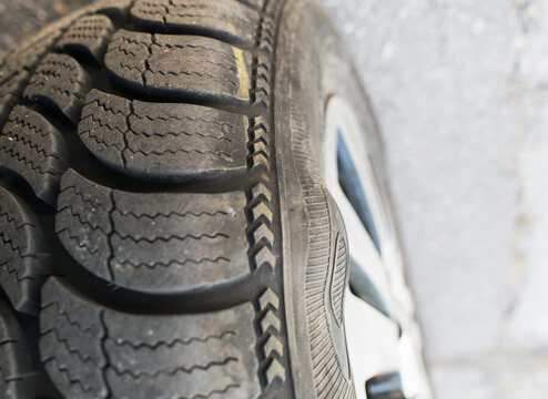 Safety hazard: car tire with a significant sidewall bump