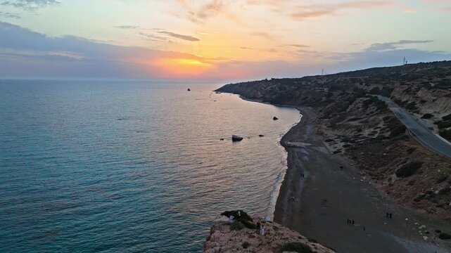 Drone view of Aphrodite&rsquo;s Rock at golden sunset in Cyprus. The large limestone rock, coastal cliffs and golden evening light create an iconic scenic landmark.