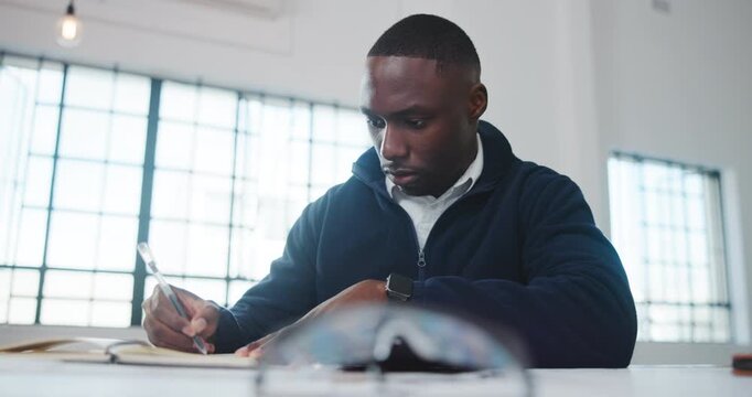 Architect, notebook or black man in agency with writing, design plan or draft of renovation project. Review, serious and engineer with notes, progress checklist and strategy brief for remodeling.