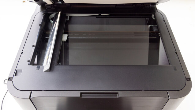 Open flatbed scanner glass surface with visible internal mechanisms