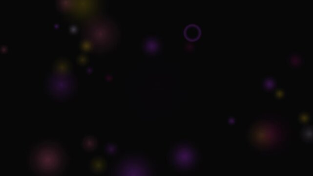 Abstract purple and yellow circles drift in a soft looping pattern across a black background