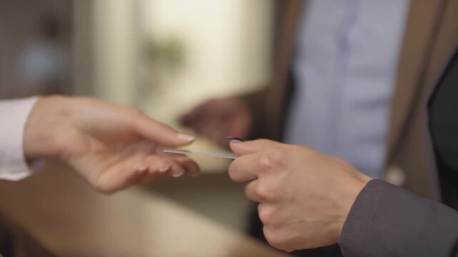 business man woman couple hand getting room key at hotel reception. clients service for check in, hospitality or accommodation with access card. Vacation, luxury guest, honeymoon or concierge. tourism