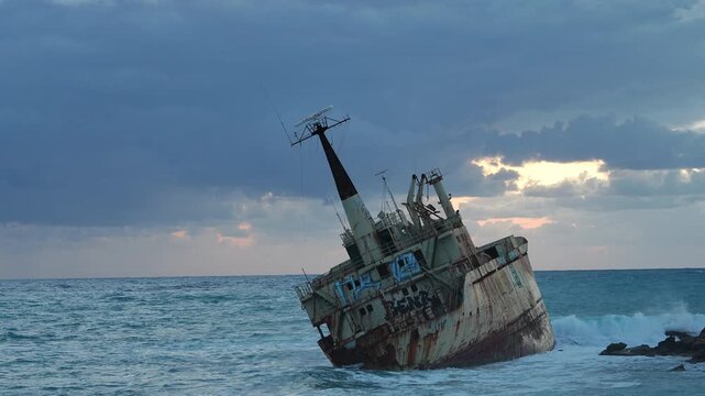 Abandoned rusty shipwreck sinking on the coast
