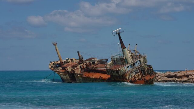 Old rusty cargo ship shipwrecked near the coast