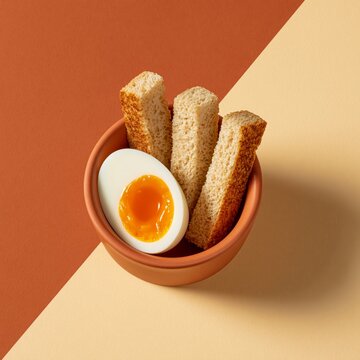 Soft boiled egg with toast in bowl