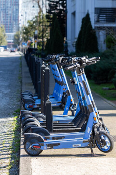 Rental electric scooters parked on city sidewalk in Batumi, Georgia, March 13, 2026