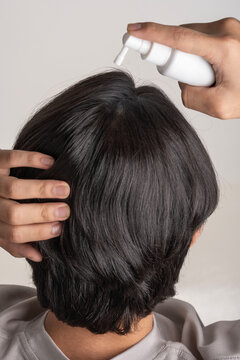 Close Up Rear View Applying Scalp Tonic Spray to Hair Roots for Growth and Nourishment