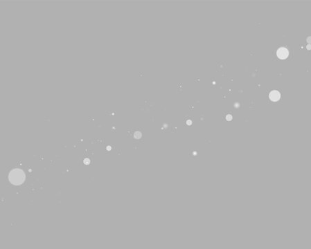 Diagonal trail of varied sized gray and white glowing particles on black background on transparent background