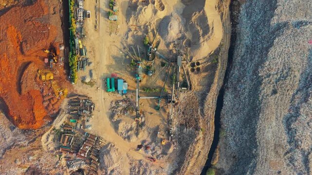 Coconut waste segregation and recycling machinery at an active waste dump yard