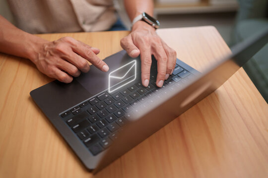 Businessman sending email on a laptop for remote communication, digital collaboration, and online workflow.