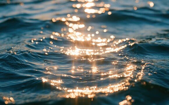 Golden sun glints dance on deep blue ocean waves