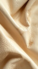Fototapeta premium Close-up of beige leather texture with wrinkles and creases.
