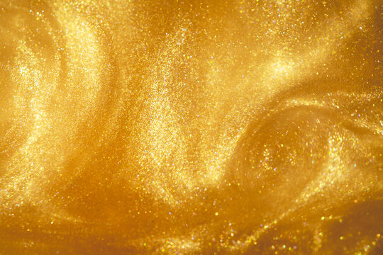 molten gold texture with flowing metallic swirls and radiant glitter reflections for jewelry promotion, beauty campaigns, festive invitations, party flyers and decorative templates.