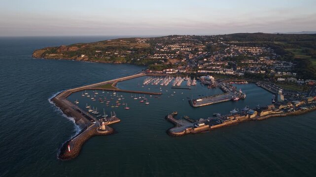 Scenic aerial of Howth town and harbour overlooking the Irish Sea at golden hour