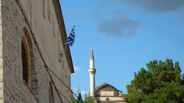 Aslan Pasha Mosque in Ioannina Greece and Greek Flag Waving From Epirus Museum, Low Angle View
