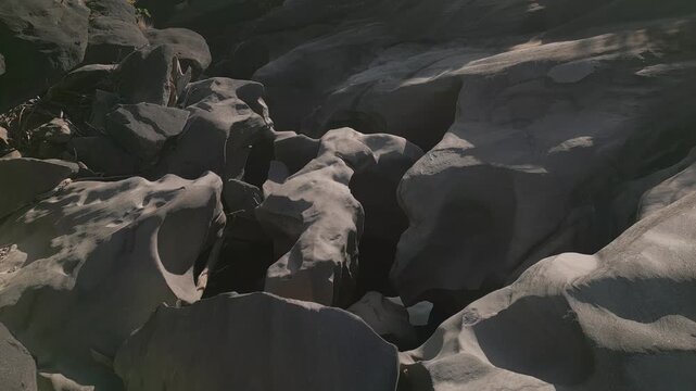Sculpted quartzite bedrock of the Sao Miguel River at Vale da Lua, Chapada dos Veadeiros National Park, Alto Paraiso de Goias, Goias, Brazil, reveals polished rock, deep erosion fissures