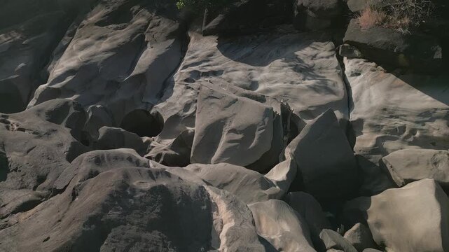 Sculpted quartzite bedrock of the Sao Miguel River at Vale da Lua, Chapada dos Veadeiros National Park, Alto Paraiso de Goias, Goias, Brazil, reveals rounded boulders, polished surfaces