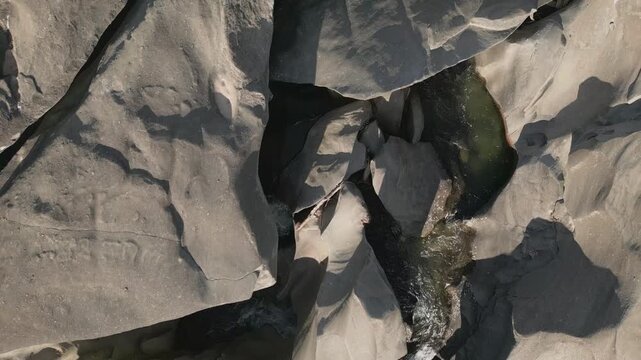 Sao Miguel River flows through sculpted quartzite bedrock at Vale da Lua, Chapada dos Veadeiros National Park, Alto Paraiso de Goias, Goias, Brazil, revealing polished rock, narrow channels and fluvia