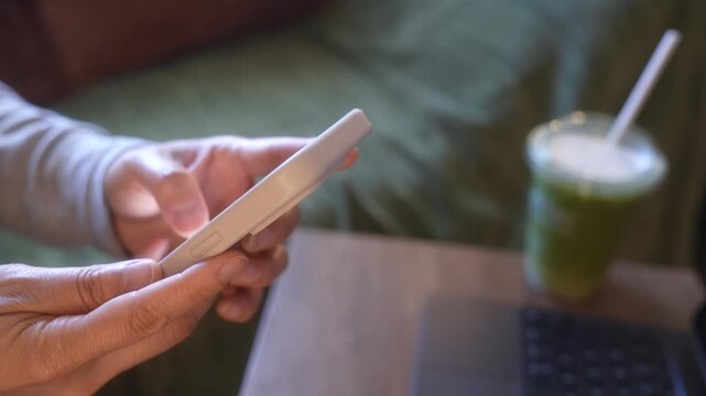 Smartphone Typing And Drinking Iced Green Tea In Morning Living Room, Close Up Hands Messaging Beside Laptop, Remote Work Break, Mobile Communication, Business Lifestyle And Home Office Routine.