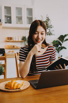 Asian woman using computer remote for business studying, watching online virtual webinar training meeting, video call. asian business woman talking on laptop in home office. Banner, copy space