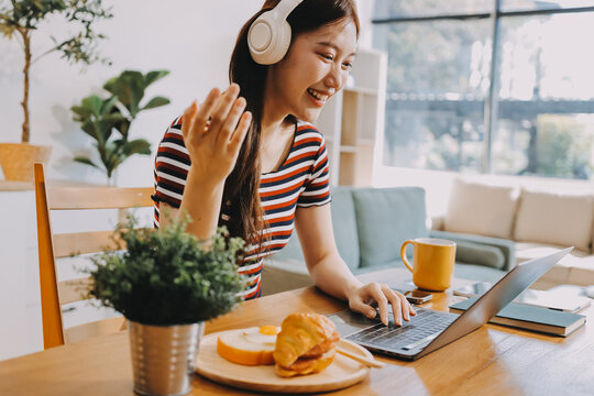 Asian woman using computer remote for business studying, watching online virtual webinar training meeting, video call. asian business woman talking on laptop in home office. Banner, copy space