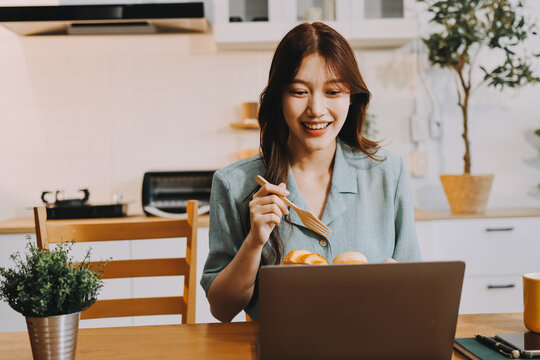 Happiness Entrepreneur beautiful business asian young woman wear casual use mobile phone for shopping online enjoy with social media and laptop at home.Small Business Startup.online banking