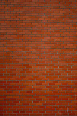 Fototapeta premium Red brick wall texture with uniform pattern and slight imperfections in surface detail