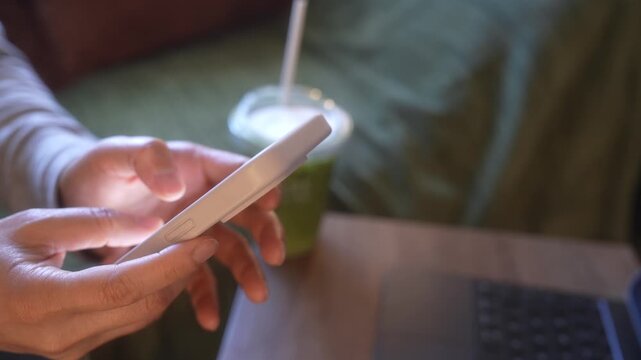 Smartphone Typing And Drinking Iced Green Tea In Morning Living Room, Close Up Hands Messaging Beside Laptop, Remote Work Break, Mobile Communication, Business Lifestyle And Home Office Routine.