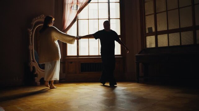 Romantic couple dancing in a sunlit vintage room