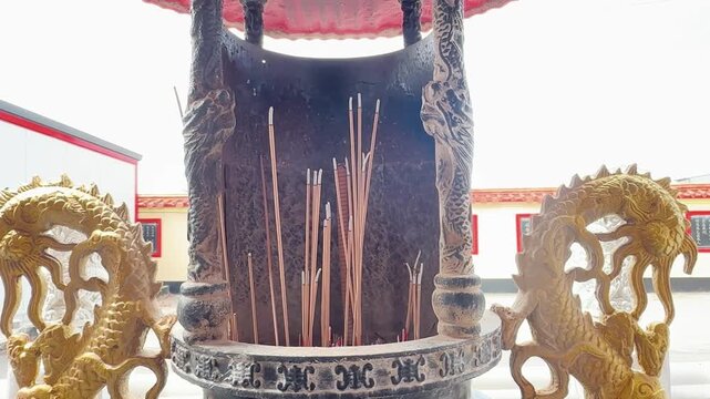 Burning Incense Sticks in Traditional Temple Incense Burner