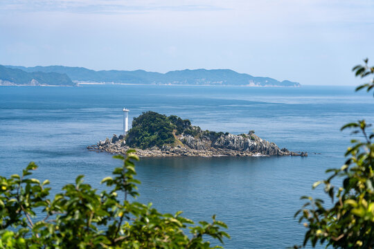 Tobishima Island with a white lighthouse floating in the Naruto Strait.